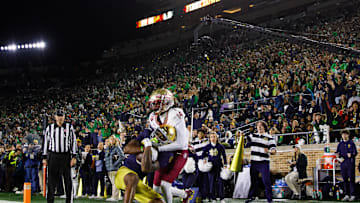 Notre Dame wide receiver Deion Colzie (0) catches a pass in the end zone for a touchdown with Florida State defensive back Cai Bates (14) defending during a NCAA college football game at Notre Dame Stadium on Saturday, Nov. 9, 2024, in South Bend.