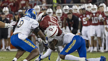 Sep 27, 2025; Stanford, California, USA;  Stanford Cardinal wide receiver CJ Williams (3) gets tackled by San Jose State Spartans linebacker Noah McNeal-Franklin (9) and linebacker Jordan Pollard (1) during the fourth quarter at Stanford Stadium. Mandatory Credit: Stan Szeto-Imagn Images

