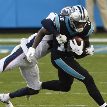 Dec 13, 2020; Charlotte, NC;  Carolina Panthers wide receiver Curtis Samuel (10) is tackled by Denver Broncos cornerback De'Vante Bausby in the fourth quarter at Bank of America Stadium.