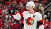 Nov 16, 2024; Raleigh, North Carolina, USA;  Ottawa Senators left wing Brady Tkachuk (7) reacts during the first period against the Carolina Hurricanes at Lenovo Center. Mandatory Credit: James Guillory-Imagn Images
