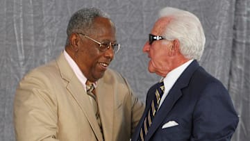 Hank Aaron shakes the hand of former Braves catcher and Hall of Fame Announce Bob Uecker, who passed away today.