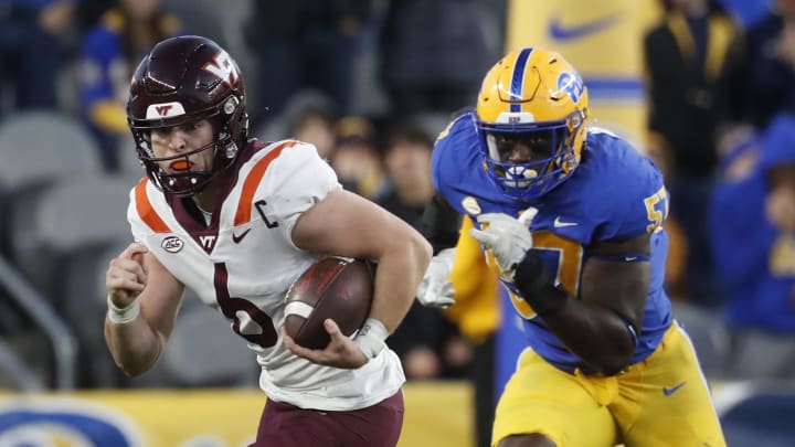 Oct 8, 2022; Pittsburgh, Pennsylvania, USA;  Virginia Tech Hokies quarterback Grant Wells (6) scrambles with the ball against Pittsburgh Panthers defensive lineman Bam Brima (57) during the fourth quarter  at Acrisure Stadium. Mandatory Credit: Charles LeClaire-USA TODAY Sports