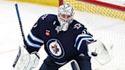 Winnipeg Jets goaltender Connor Hellebuyck makes a glove save against the St. Louis Blues.