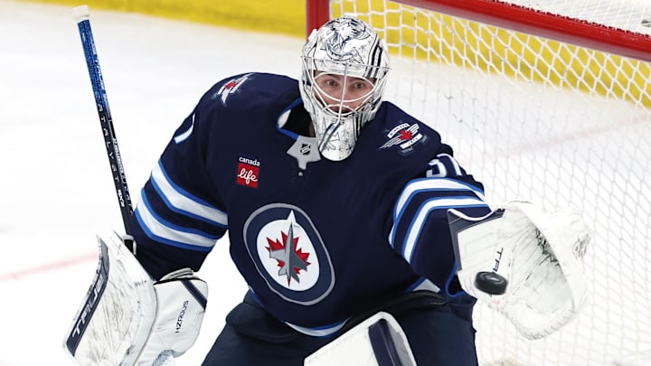 Winnipeg Jets goaltender Connor Hellebuyck makes a glove save against the St. Louis Blues.