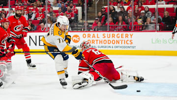 Mar 25, 2025; Raleigh, North Carolina, USA;  Nashville Predators right wing Luke Evangelista (77) scores a goal past Carolina Hurricanes goaltender Pyotr Kochetkov (52) during the second period at Lenovo Center. Mandatory Credit: James Guillory-Imagn Images