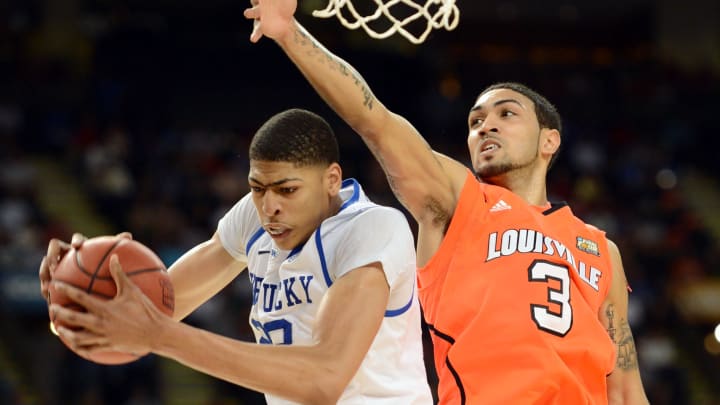 Mar 31, 2012; New Orleans, LA, USA; Kentucky Wildcats forward Anthony Davis (left) pulls down a rebound against Louisville Cardinals guard Peyton Siva during the second half in the semifinals of the 2012 NCAA men's basketball Final Four at the Mercedes-Benz Superdome. Kentucky won 69-61. Mandatory Credit: Bob Donnan-USA TODAY Sports