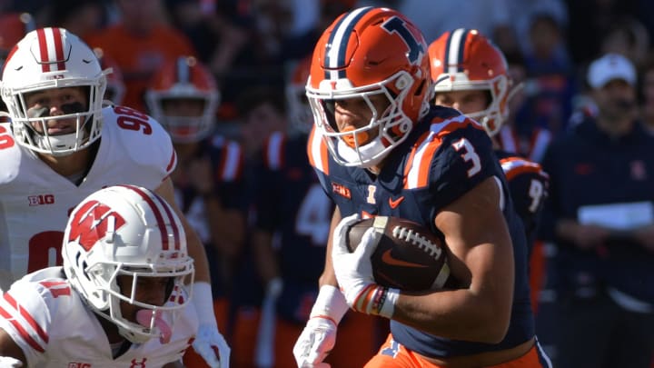 Oct 21, 2023; Champaign, Illinois, USA;  Illinois Fighting Illini running back Kaden Feagin (3) runs the ball against Wisconsin Badgers cornerback Alexander Smith (11) during the first half at Memorial Stadium. Mandatory Credit: Ron Johnson-USA TODAY Sports