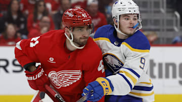 Apr 7, 2024; Detroit, Michigan, USA; Detroit Red Wings defenseman Shayne Gostisbehere (41) and Buffalo Sabres left wing Zach Benson (9) fight for position in the third period at Little Caesars Arena. Mandatory Credit: Rick Osentoski-Imagn Images