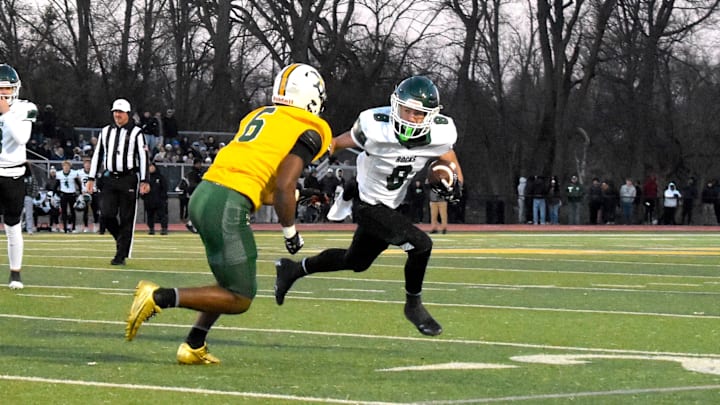 Trinity High School running back Ashton Taylor tries to beat St. Xavier's  Marlon Harbin III to the outside Friday, Nov. 28, 2025, in a 6A state semifinal game between the programs.