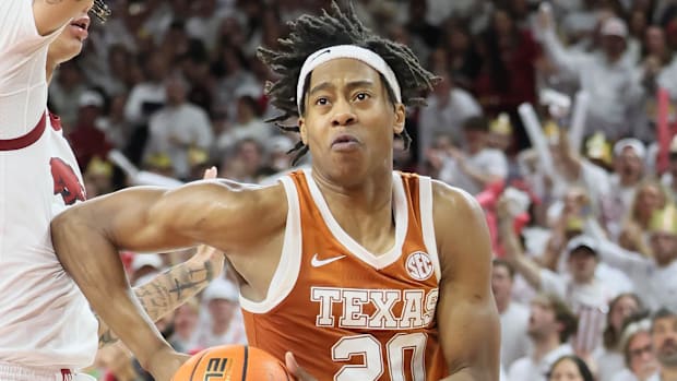 Texas Longhorns guard Tre Johnson drives against Arkansas Razorbacks forward Trevon Brazile for two of his career-high 39
