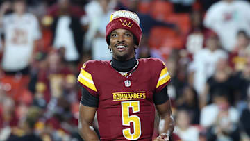 Aug 18, 2025; Landover, Maryland, USA; Washington Commanders quarterback Jayden Daniels (5) request the ball after Commanders running back Jacory Croskey-Merritt (not pictured) scores a touchdown against Cincinnati Bengals during the first half at Northwest Stadium. Mandatory Credit: Amber Searls-Imagn Images