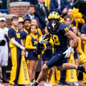 Michigan tight end Colston Loveland (18) makes a catch against Texas defensive back Derek Williams Jr. (2) during the first half at Michigan Stadium in Ann Arbor on Saturday, September 7, 2024.