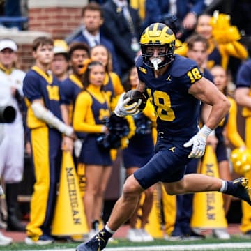 Michigan tight end Colston Loveland (18) makes a catch against Texas defensive back Derek Williams Jr. (2) during the first half at Michigan Stadium in Ann Arbor on Saturday, September 7, 2024.