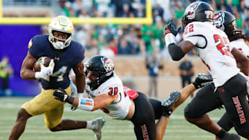 Notre Dame running back Jadarian Price, left, runs with the ball as NC State linebacker Zane Williams (30) chases in the second half of a NCAA football game at Notre Dame Stadium on Saturday, Oct. 11, 2025, in South Bend.