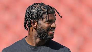 Cleveland Browns quarterback Shedeur Sanders is all smiles as he warms up before an NFL football game at Huntington Bank Field, Sept. 21, 2025, in Cleveland, Ohio.