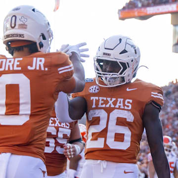 Dec 21, 2024; Austin, Texas, USA; Texas Longhorns running back Quintrevion Wisner (26) celebrates a touchdown with wide receiver DeAndre Moore Jr. (0) against the Clemson Tigers during the CFP National playoff first round at Darrell K Royal-Texas Memorial Stadium. Mandatory Credit: Mark J. Rebilas-Imagn Images