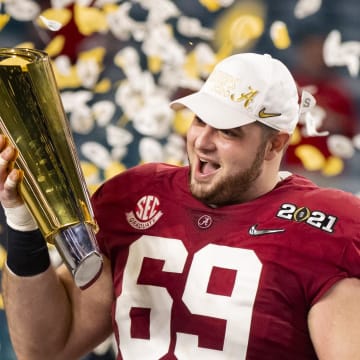 Jan 11, 2021; Miami Gardens, Florida, USA; Alabama Crimson Tide offensive lineman Landon Dickerson (69) celebrates with the CFP National Championship trophy after beating the Ohio State Buckeyes in the 2021 College Football Playoff National Championship Game. 