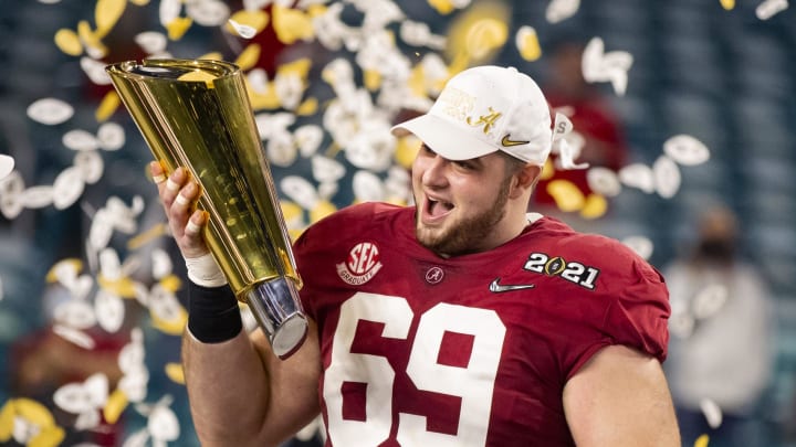 Jan 11, 2021; Miami Gardens, Florida, USA; Alabama Crimson Tide offensive lineman Landon Dickerson (69) celebrates with the CFP National Championship trophy after beating the Ohio State Buckeyes in the 2021 College Football Playoff National Championship Game. 