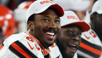 Cleveland Browns defensive end Myles Garrett (left) laughs as he watches a video on the scoreboard during a preseason game against Washington on Aug. 8, 2019, in Cleveland, Ohio.
