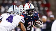 Sep 12, 2025; Tucson, Arizona, USA; Arizona Wildcats running back Ismail Mahdi (21) runs the ball while Kansas State Wildcats safety Daniel Cobbs (4) defends during the fourth quarter at Arizona Stadium. Mandatory Credit: Aryanna Frank-Imagn Images