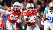 Ohio State Buckeyes running back Isaiah West (32) runs past UCLA Bruins defensive back Scooter Jackson (28) during the NCAA football game at Ohio Stadium in Columbus on Nov. 15, 2025.