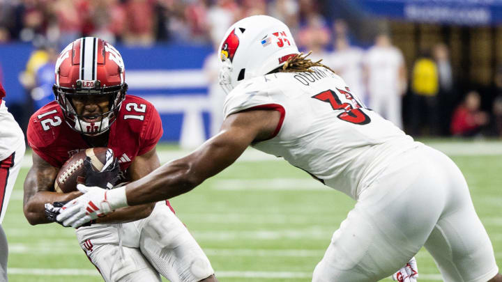 Sep 16, 2023; Indianapolis, Indiana, USA; Indiana Hoosiers running back Jaylin Lucas (12) runs the ball against Louisville Cardinals linebacker TJ Quinn (34) in the second half at Lucas Oil Stadium.