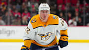 Dec 15, 2023; Raleigh, North Carolina, USA;  Nashville Predators defenseman Tyson Barrie (22) watches the play against the Carolina Hurricanes during the second period at PNC Arena. Mandatory Credit: James Guillory-Imagn Images