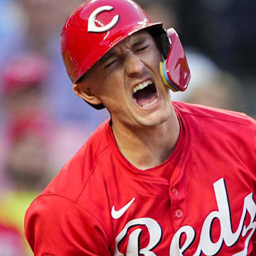 May 28, 2025; Kansas City, Missouri, USA; Cincinnati Reds designated hitter Austin Hays (12) reacts after fouling a ball off of his leg during the sixth inning against the Kansas City Royals at Kauffman Stadium. Mandatory Credit: Jay Biggerstaff-Imagn Images