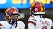 Oct 5, 2025; Inglewood, California, USA; Washington Commanders quarterback Jayden Daniels (5) celebrates with wide receiver Deebo Samuel Sr. (1) after a touchdown against the Los Angeles Chargers in the second half at SoFi Stadium. Mandatory Credit: Jayne Kamin-Oncea-Imagn Images