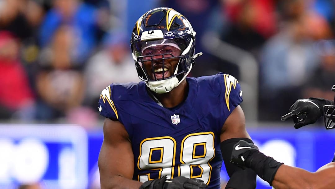Dec 27, 2025; Inglewood, California, USA;  Los Angeles Chargers linebacker Odafe Oweh (98) and linebacker Daiyan Henley (0) react after a defensive play against the Houston Texans during the second half at SoFi Stadium. Mandatory Credit: Gary A. Vasquez-Imagn Images