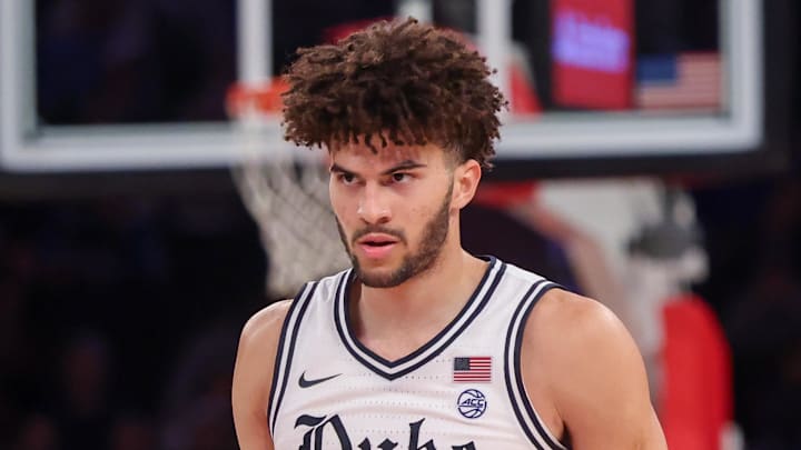Nov 18, 2025; New York, New York, USA; Duke Blue Devils forward Cameron Boozer (12) reacts against the Kansas Jayhawks during the second half at Madison Square Garden. Mandatory Credit: Vincent Carchietta-Imagn Images