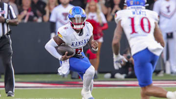 Oct 11, 2025; Lubbock, Texas, USA;  Kansas Jayhawks quarterback Jalon Daniels (6) scrambles against the Texas Tech Red Raiders in the first half at Jones AT&T Stadium. Mandatory Credit: Michael C. Johnson-Imagn Images