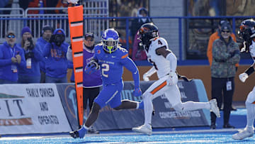 Nov 29, 2024; Boise, Idaho, USA; Boise State Broncos running back Ashton Jeanty (2) runs against Boise State Broncos safety Rodney Robinson (4) during the second quarter at Albertsons Stadium. Mandatory Credit: Brian Losness-Imagn Images


