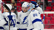 Oct 11, 2024; Raleigh, North Carolina, USA;  Tampa Bay Lightning goaltender Andrei Vasilevskiy (88) and defenseman Emil Lilleberg (78) celebrate their victory against the Carolina Hurricanes at PNC Arena. Mandatory Credit: James Guillory-Imagn Images