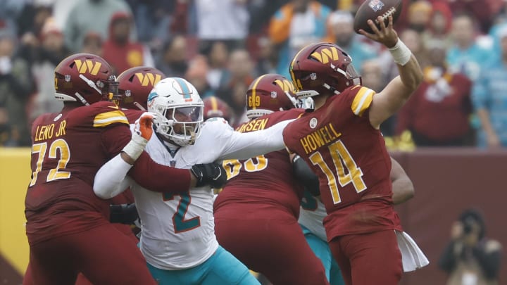 Washington Commanders quarterback Sam Howell (14) passes the ball as Miami Dolphins linebacker Bradley Chubb (2) chases during the second quarter at FedExField last season.