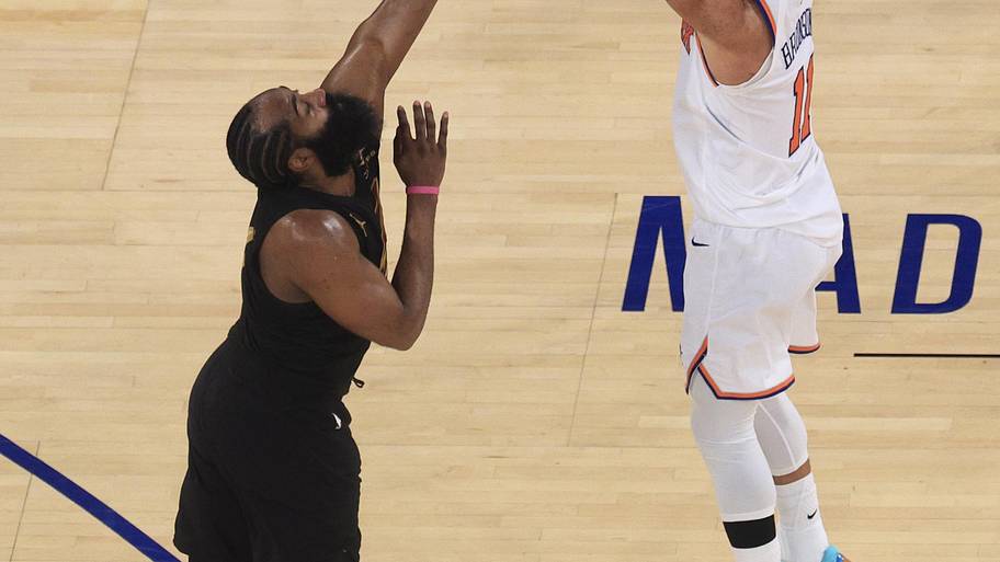 New York Knicks guard Jalen Brunson makes a three point basket against Cleveland Cavaliers guard James Harden.