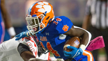 Madison Central's Glen Singleton (14) pushes past Clinton in Madison, Miss., Friday, Oct. 7, 2022.