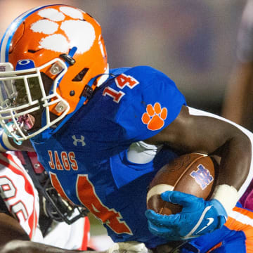 Madison Central's Glen Singleton (14) pushes past Clinton in Madison, Miss., Friday, Oct. 7, 2022.