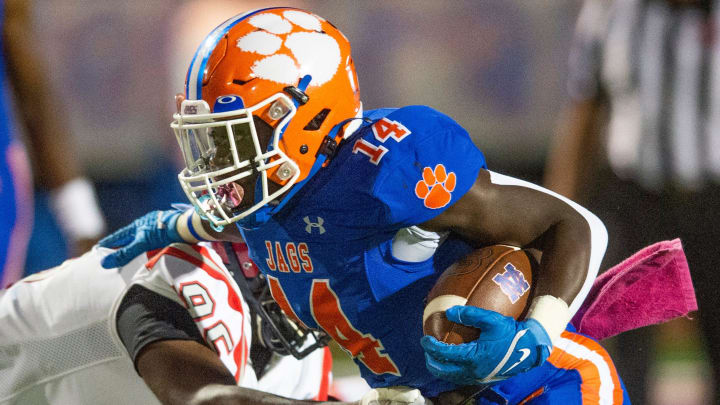 Madison Central's Glen Singleton (14) pushes past Clinton in Madison, Miss., Friday, Oct. 7, 2022.