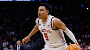 Mar 20, 2025; Denver, CO, USA; Wisconsin Badgers guard John Tonje (9) dribbles the ball against the Montana Grizzlies during the first half in the first round of the NCAA Tournament at Ball Arena. Mandatory Credit: Isaiah J. Downing-Imagn Images