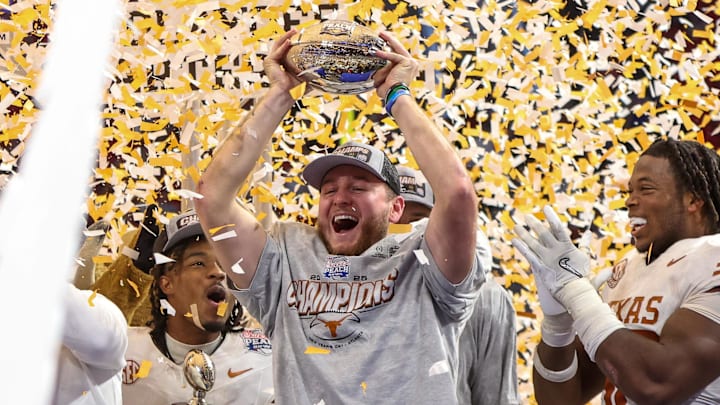 Jan 1, 2025; Atlanta, GA, USA; Texas Longhorns quarterback Quinn Ewers (3) holds up the trophy after a victory over the Arizona State Sun Devils in the Peach Bowl at Mercedes-Benz Stadium. Mandatory Credit: Brett Davis-Imagn Images Jan 1, 2025; Atlanta, GA, USA; Texas Longhorns quarterback Quinn Ewers (3) holds up the trophy after a victory over the Arizona State Sun Devils in the Peach Bowl at Mercedes-Benz Stadium. Mandatory Credit: Brett Davis-Imagn Images