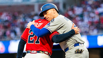 Los Angeles Dodgers first baseman Freddie Freeman hugs Atlanta Braves third baseman Austin Riley