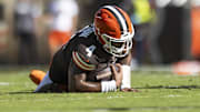 Oct 20, 2024; Cleveland, Ohio, USA; Cleveland Browns quarterback Deshaun Watson (4) falls to the ground with a torn Achilles during the second quarter against the Cincinnati Bengals at Huntington Bank Field. Mandatory Credit: Scott Galvin-Imagn Images