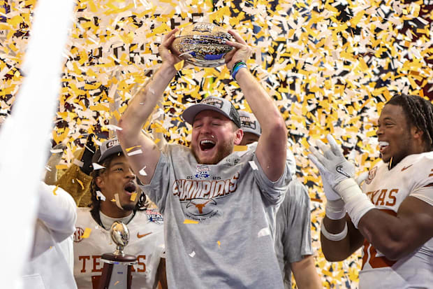Ewers celebrates with teammates after winning the Peach Bowl to advance to the CFP semifinals.