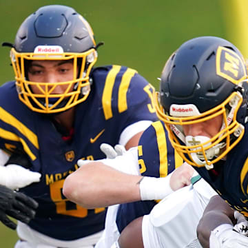 Trinity Shamrocks Juleone Carney (8) tackles Moeller Crusaders running back Tyler Josleyn (12) in the first half of a high school football game between the Moeller Crusaders and Trinity Shamrocks, Friday, Sept. 5, 2025, at Mount St. Joseph University’s Schueler Field in Cincinnati.