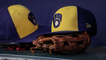 Jul 28, 2023; Atlanta, Georgia, USA; A detailed view of a Milwaukee Brewers hat and glove on the bench against the Atlanta Braves in the second inning at Truist Park. Mandatory Credit: Brett Davis-Imagn Images