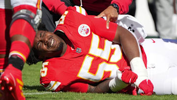 Oct 19, 2025; Kansas City, Missouri, USA; Kansas City Chiefs defensive tackle Omarr Norman-Lott (55) is checked on by a trainer after an injury against the Las Vegas Raiders during the third quarter of the game at GEHA Field at Arrowhead Stadium