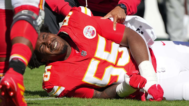 Oct 19, 2025; Kansas City, Missouri, USA; Kansas City Chiefs defensive tackle Omarr Norman-Lott (55) is checked on by a trainer after an injury against the Las Vegas Raiders during the third quarter of the game at GEHA Field at Arrowhead Stadium