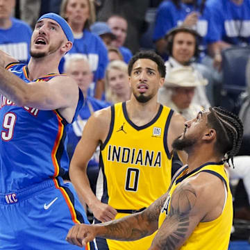 Jun 8, 2025; Oklahoma City, Oklahoma, USA; Oklahoma City Thunder guard Alex Caruso (9) drives to the basket past Indiana Pacers guard Tyrese Haliburton (0) during the fourth quarter of game two of the 2025 NBA Finals at Paycom Center. Mandatory Credit: Kyle Terada-Imagn Images