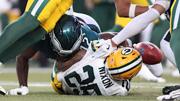 Jan 12, 2025; Philadelphia, Pennsylvania, USA; Philadelphia Eagles linebacker Oren Burks (42) causes a fumble on the opening kick off against the Green Bay Packers during the first quarter in the NFC wild card game at Lincoln Financial Field. Mandatory Credit: Bill Streicher-Imagn Images